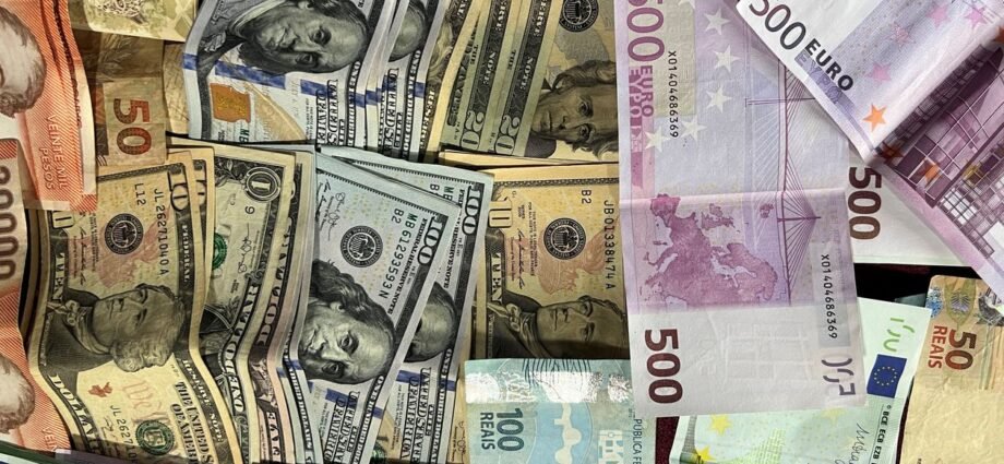 International banknotes representing currency transfer for buying UK luxury property from abroad
