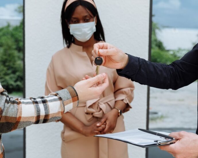 Landlord handing over keys representing the Non-Resident Landlord Scheme for UK rental property