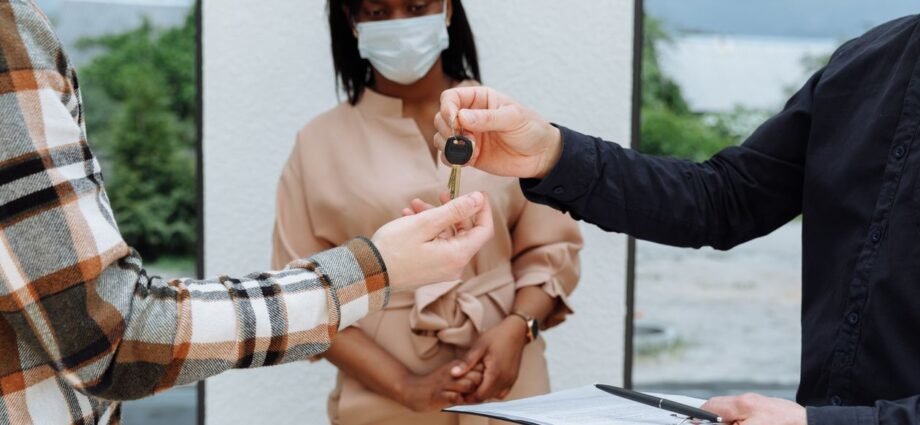 Landlord handing over keys representing the Non-Resident Landlord Scheme for UK rental property